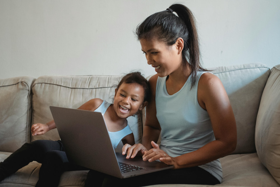 woman with child looking at computer