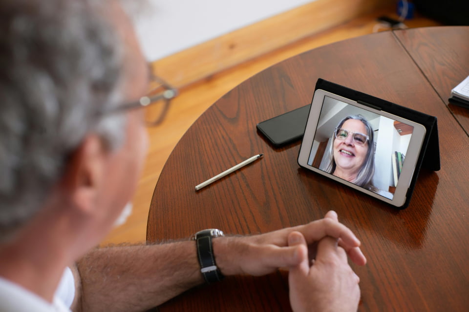 man looking at tablet in divorce counseling session